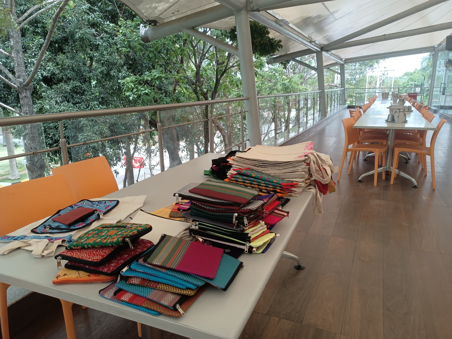 Cotton tote bags and pouches laid out at a Wings of Desire stall