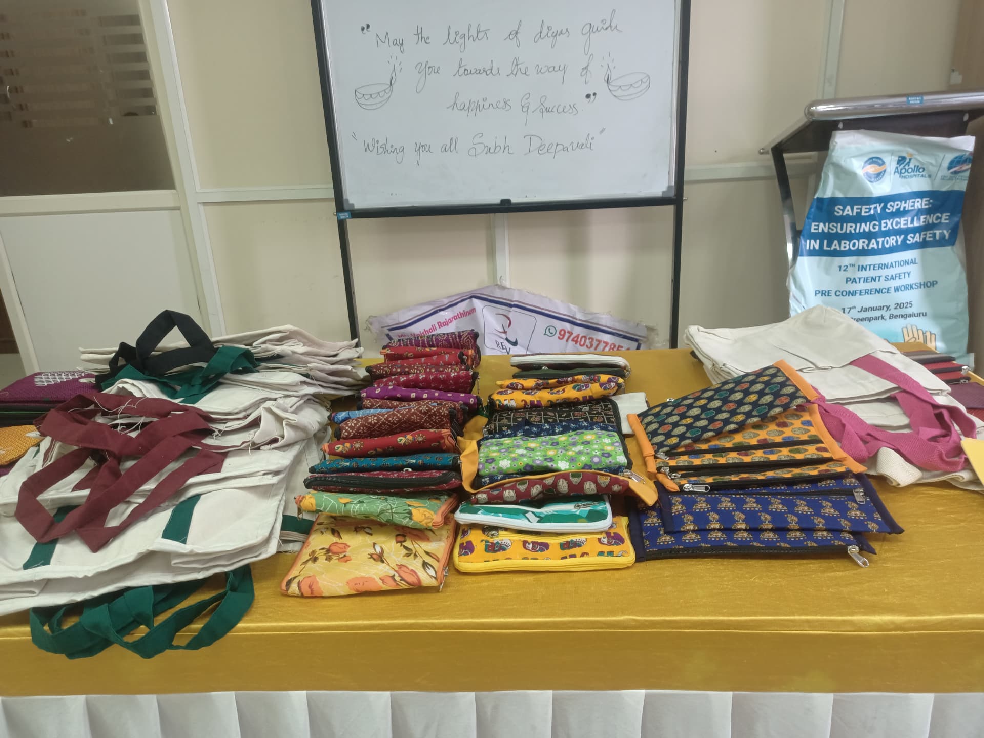 Assorted handmade pouches and cotton bags arranged on a stall table