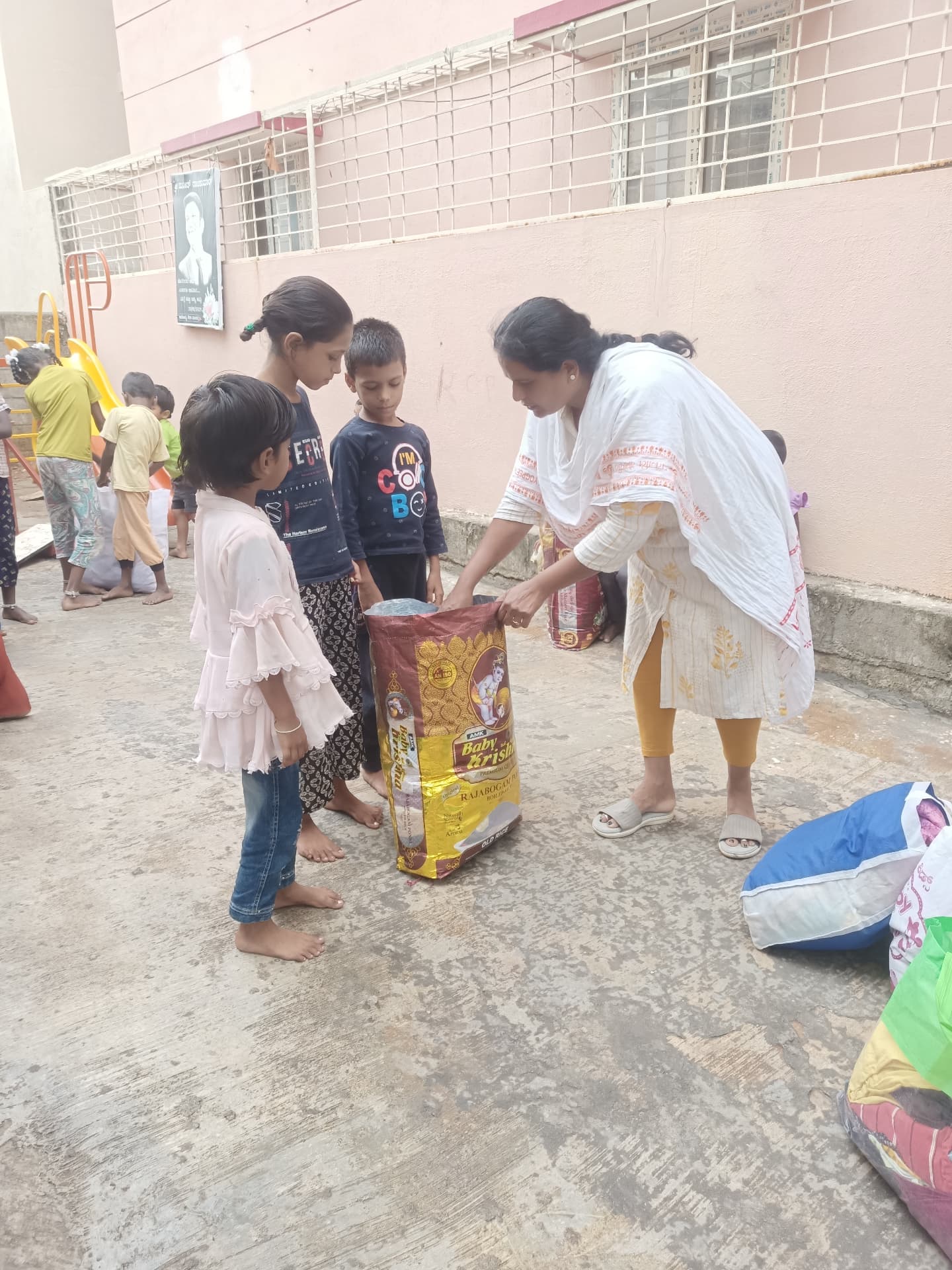 Rice and grocery donations being handed to children